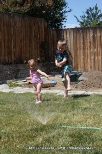 Ethan and Autumn in the sprinklers