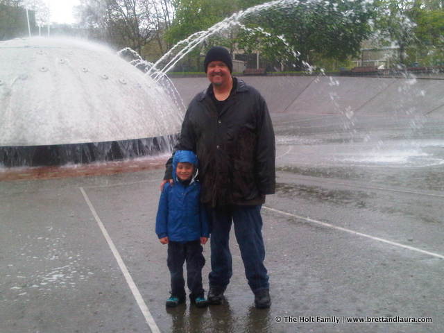 Uncle Mark and Ethan in the rain in the fountain at Seattle Center